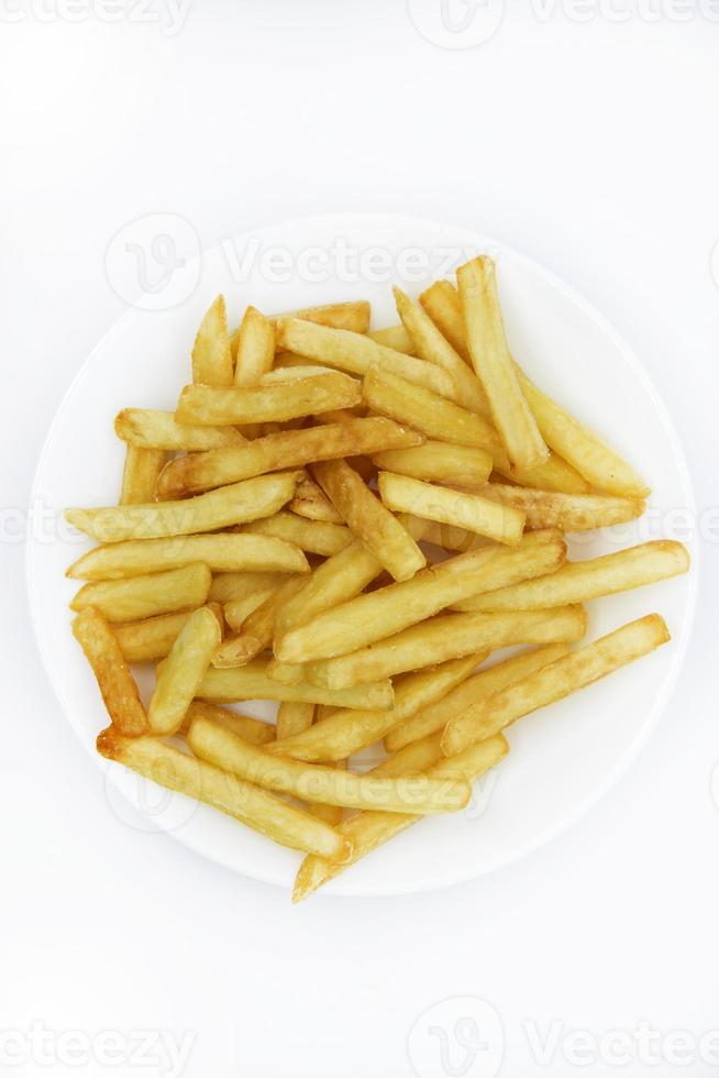 Yellow delicious French fries in white dishes. Fast food on a plate. Fried potatoes. Toasted potato slices on a white background. photo