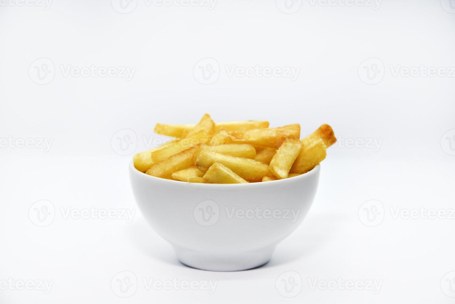 Yellow delicious French fries in white dishes. Fast food on a plate. Fried potatoes. Toasted potato slices on a white background. photo
