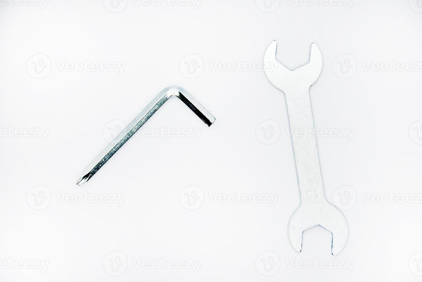 Two iron construction keys on a white background. A horn wrench and a screwdriver. photo