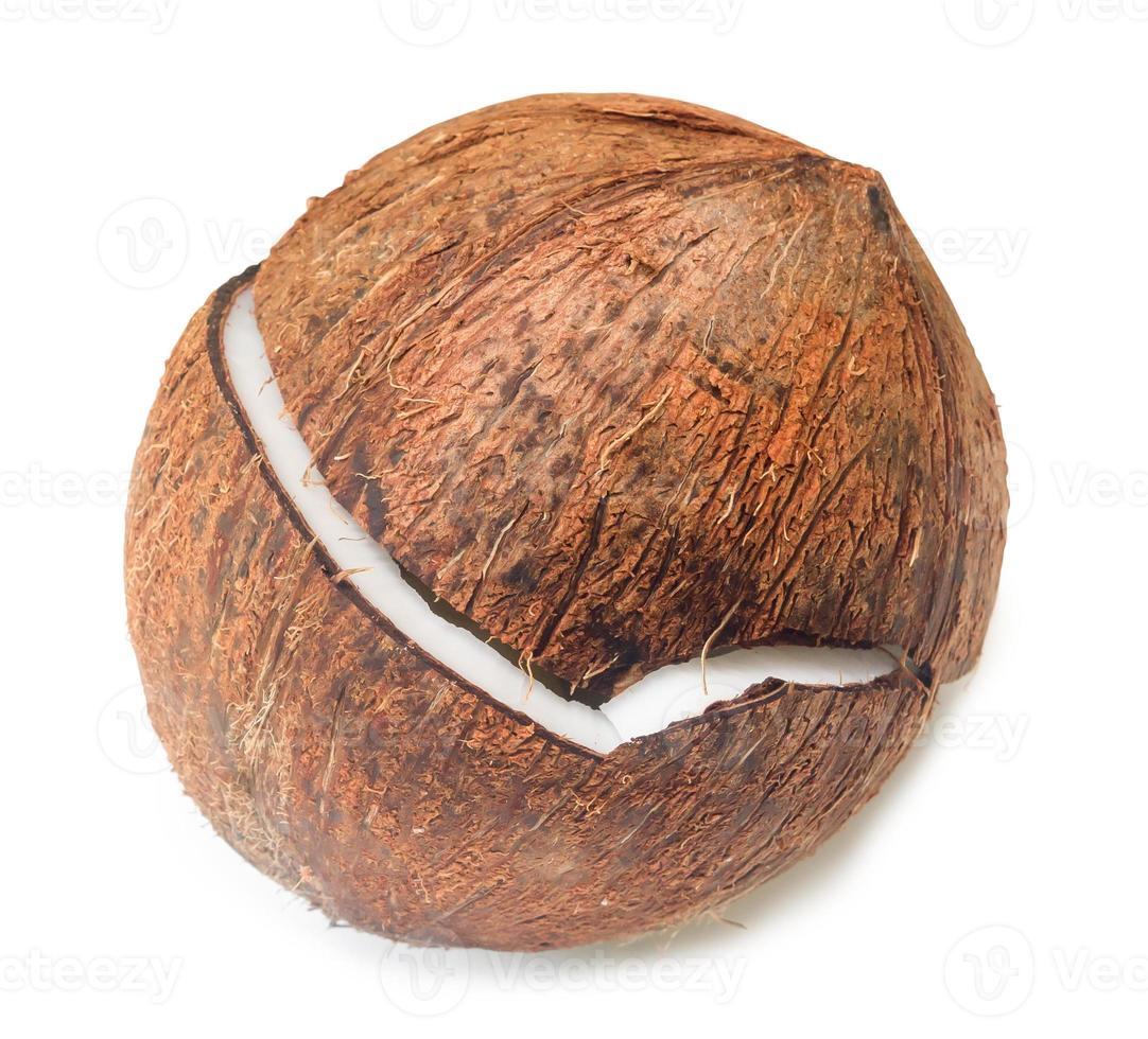 Single cracked ripe coconut fruit isolated on white background with clipping path. The peeled coconut fruit halved to prepare for food ingredient as coconut milk photo