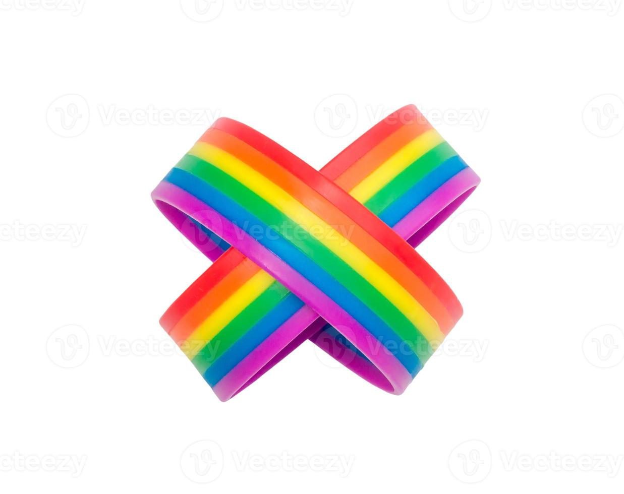 Two colorful rainbow wristbands in multiplication sign, lgbtq people symbol isolated on white background with clipping path. Concept of lgbtq wristband wearing to support and attend celebration event photo