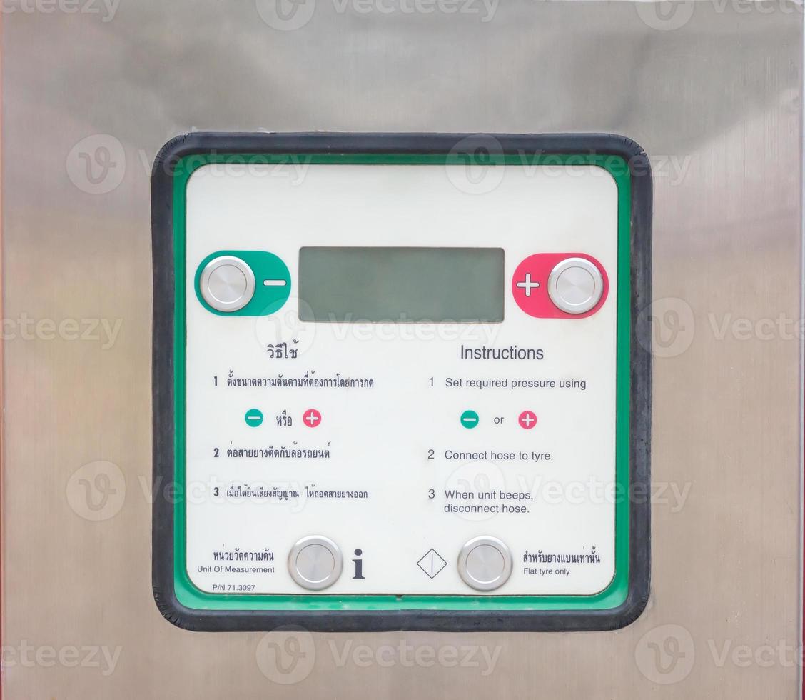 Viewdata screen or monitor with in structions of automatic tire inflator free served at gas station in downtown area photo