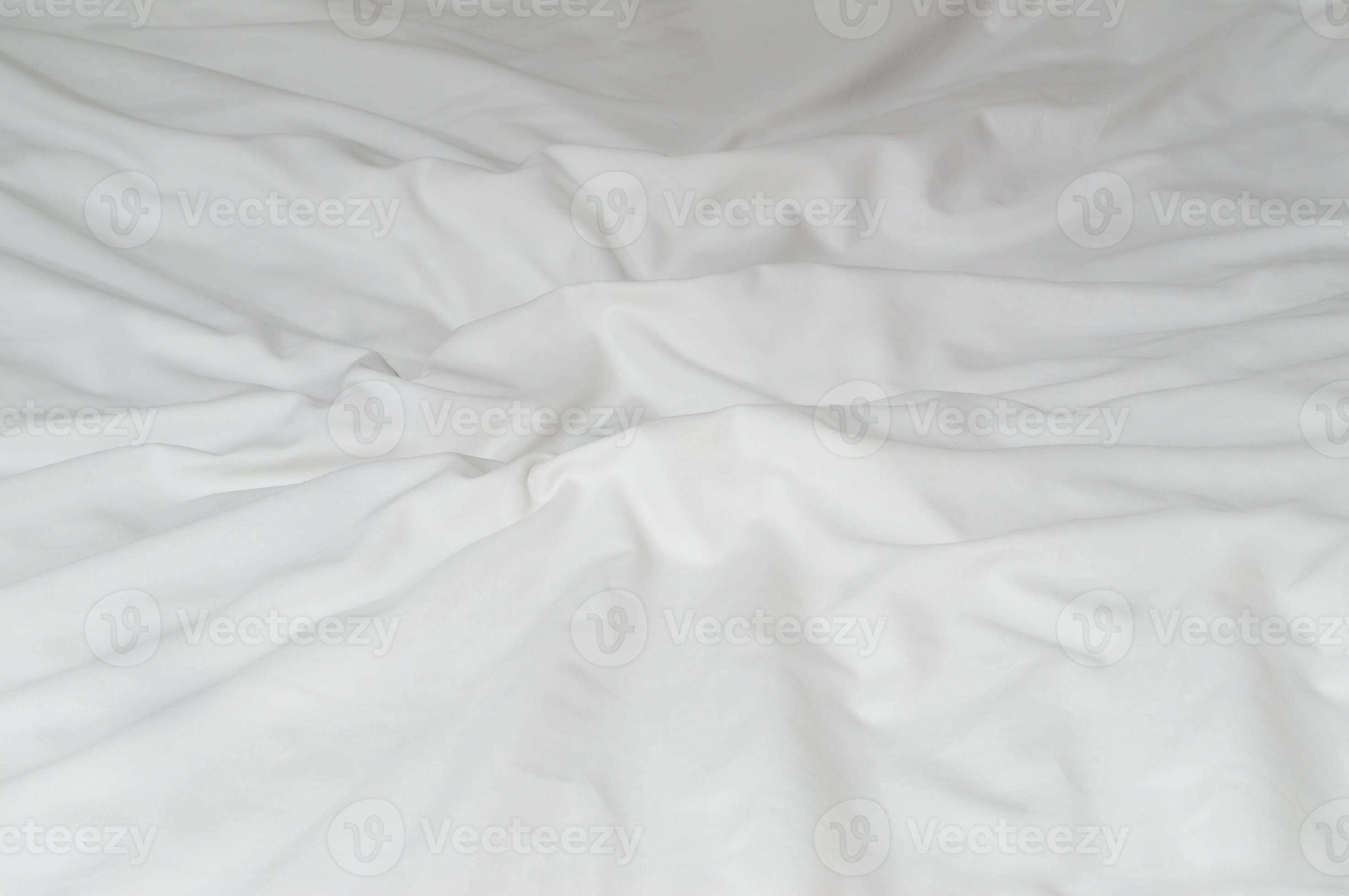 White crumpled or wrinkled bedding sheet or blanket with pattern after