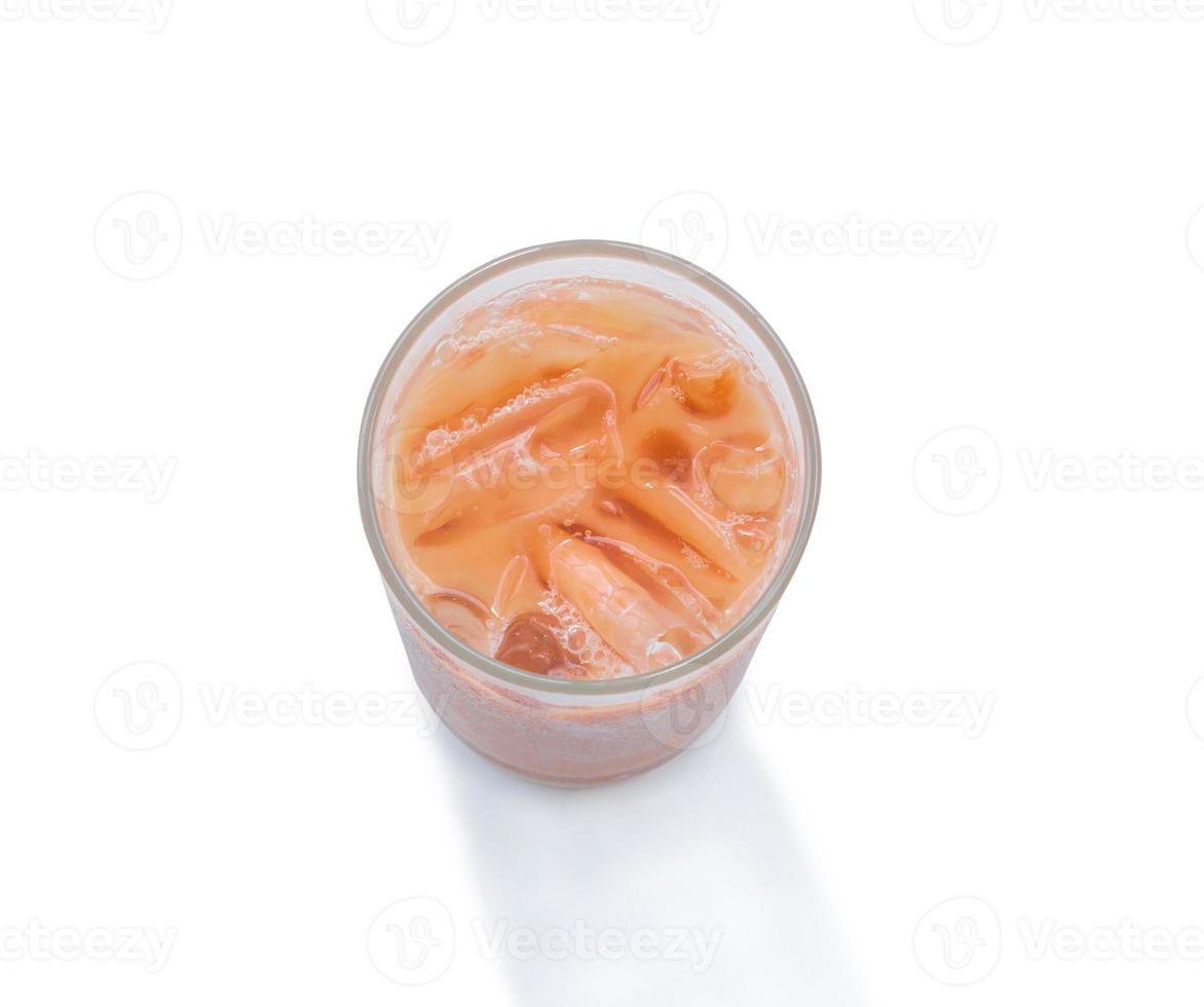Top view of orange Thai  iced condensed milk tea in transparent glass isolated on white background with clipping path photo