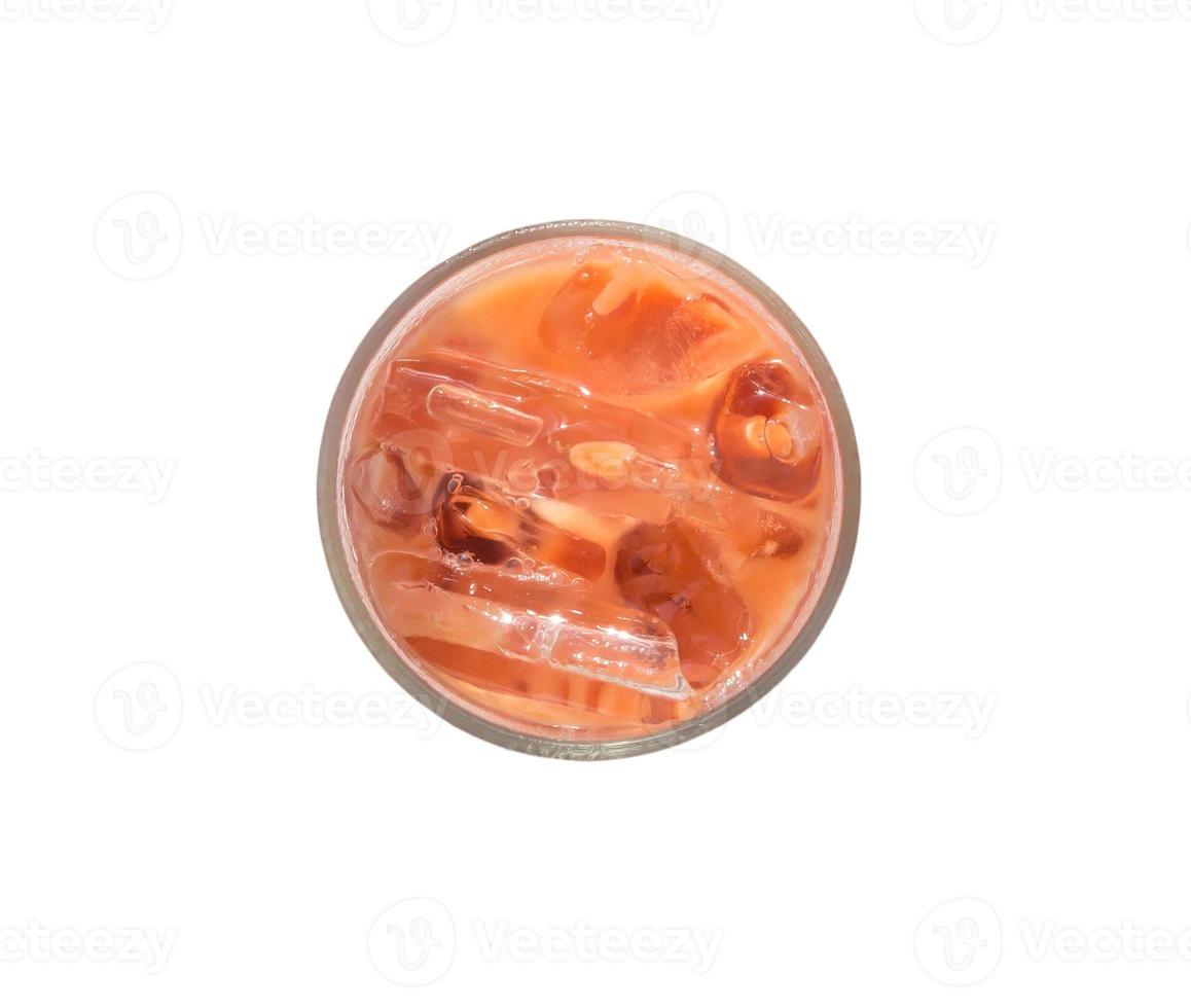 Top view of orange iced condensed Thai milk tea in transparent glass isolated on white background with clipping path photo