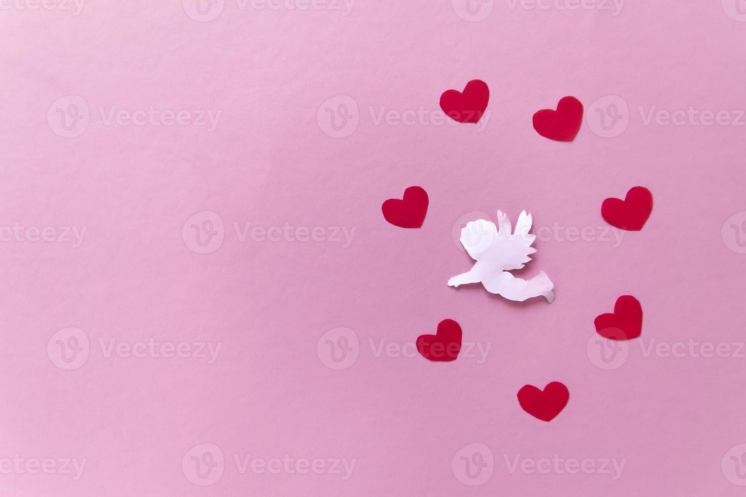 valentines day consept. red color hearts and cupid aiming in heart on pink background. valentines day cards. photo