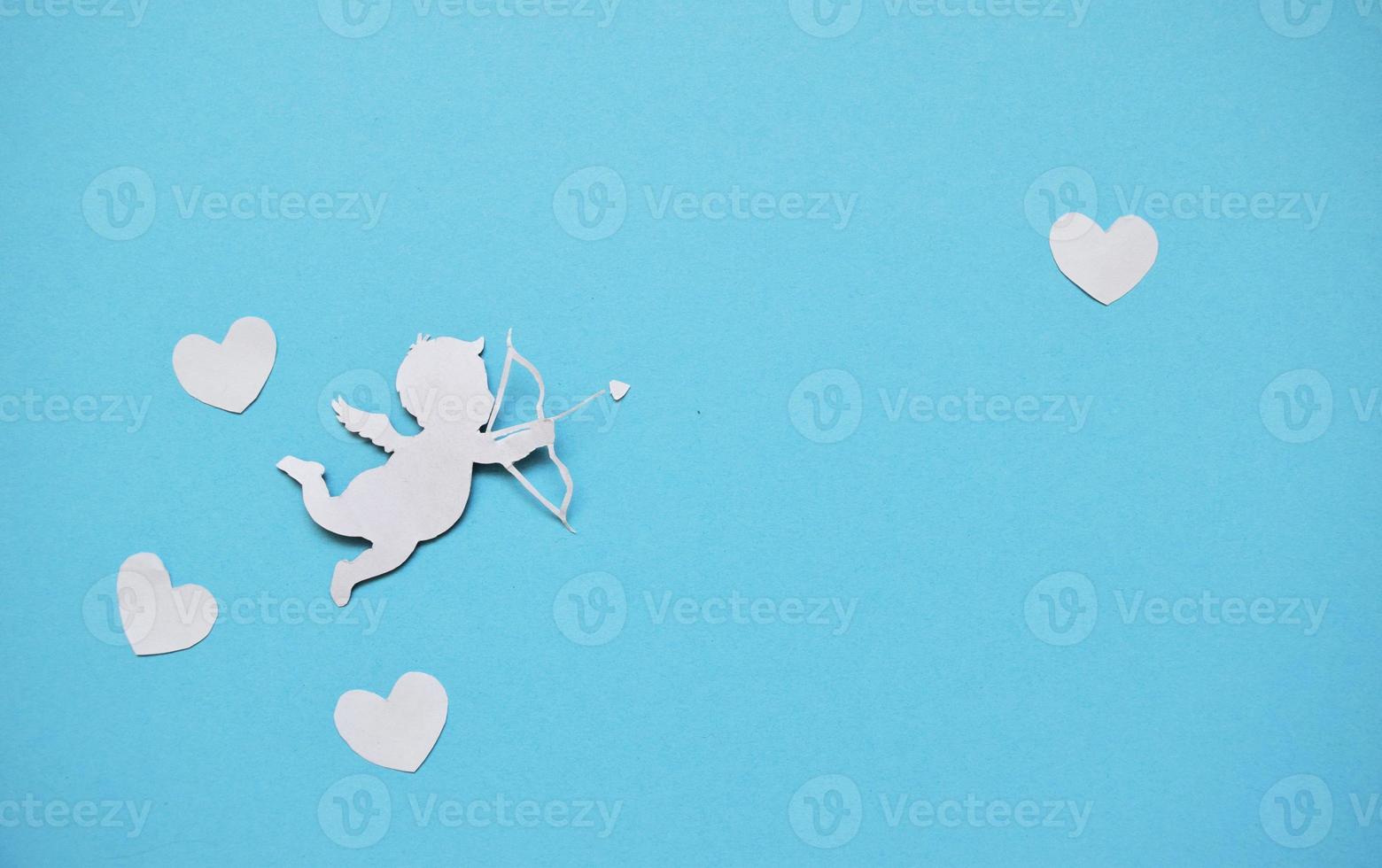 valentines day consept. white hearts and cupid aiming in heart on blue background. valentines day cards. photo