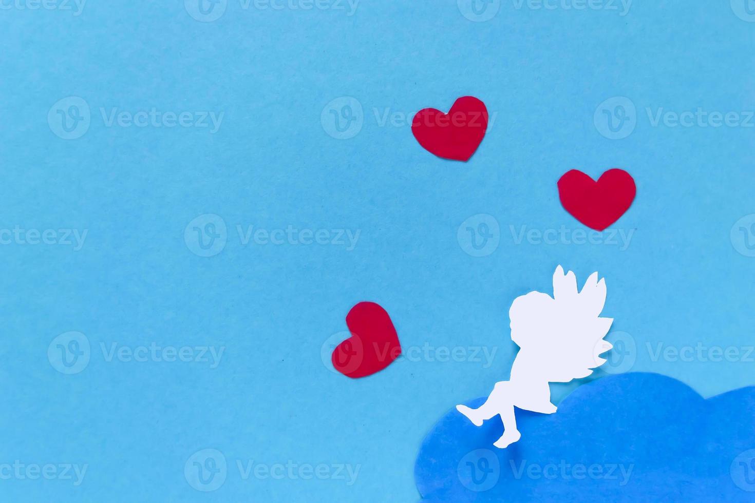 valentines day consept. red hearts and cupid aiming in heart on blue background. creative valentine's day card. photo