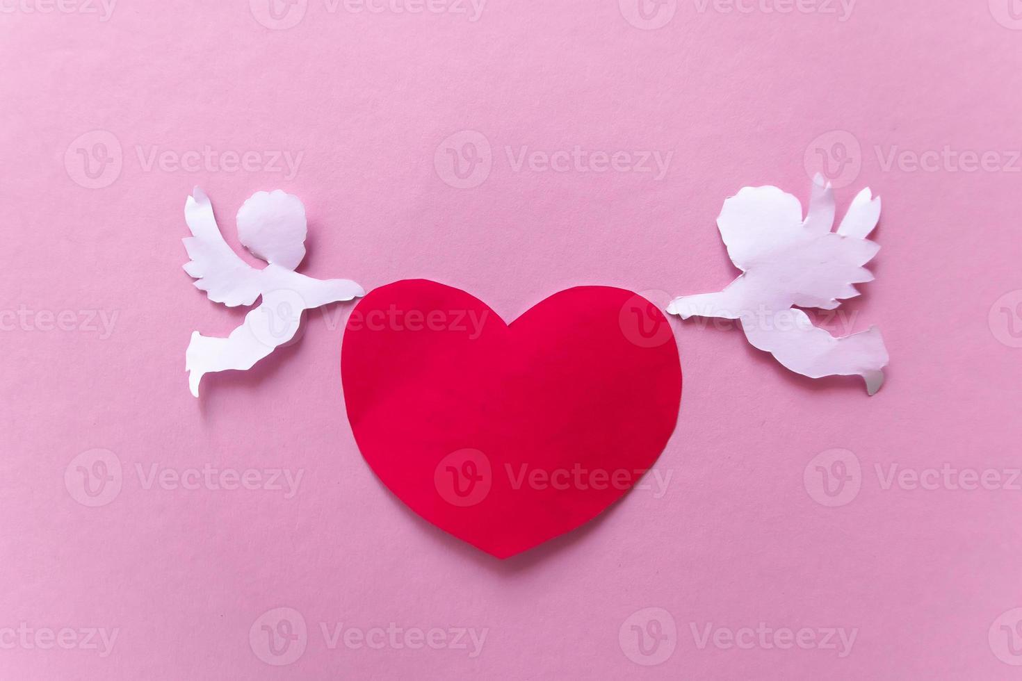 valentines day consept. red hearts and cupid on pink background. valentine's day card. photo