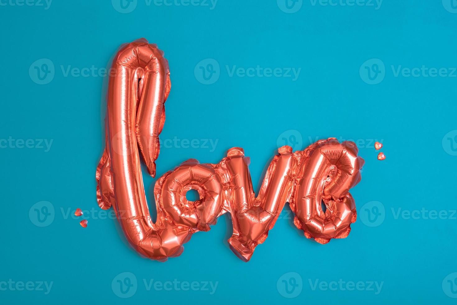 Red baloons Love shape on turquoise background. Valentines Day concept. photo