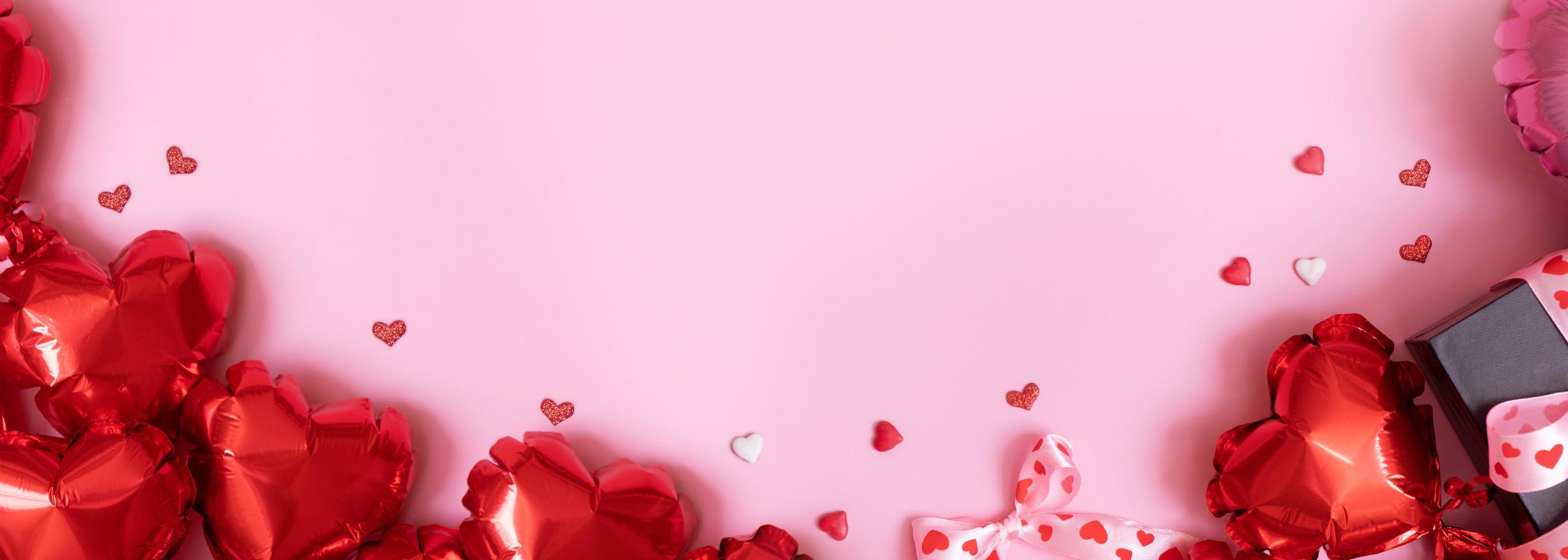 Happy Valentines Day greeting card background. Banner with gift box with bow and heart shape baloons on pink background photo