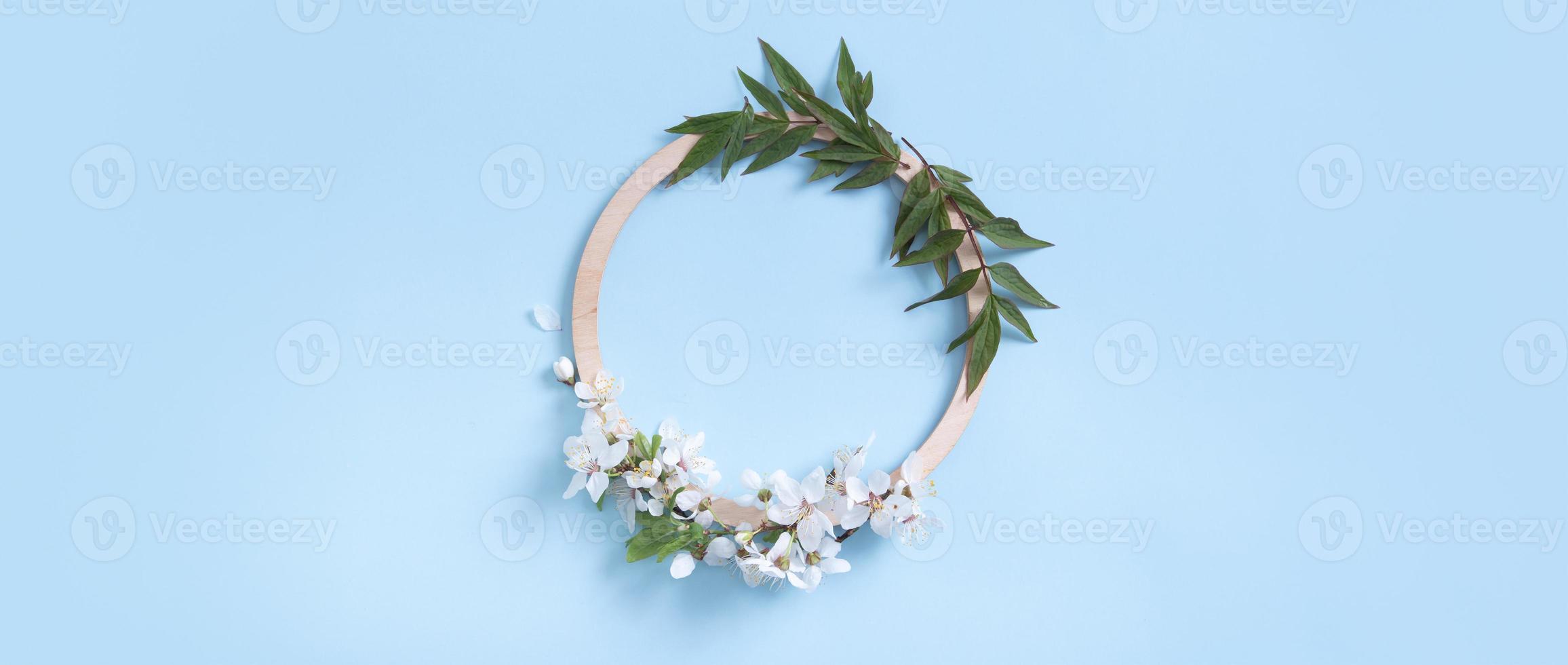 Banner with round wooden frame with blossom flower and leaves mock up flat lay for your text photo