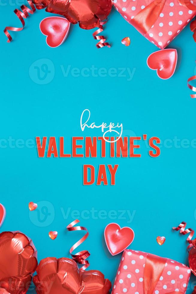 Happy Valentines Day greeting card vertical format. Gift box and red heart shape baloons on turquoise background photo