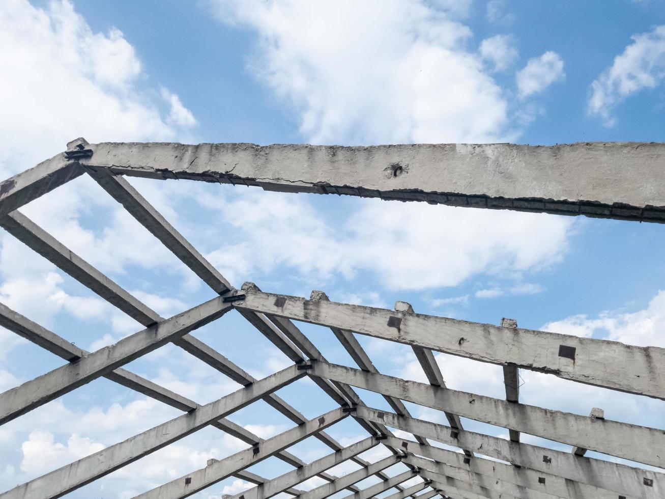 The concrete frame of the gable roof of an abandoned building. photo