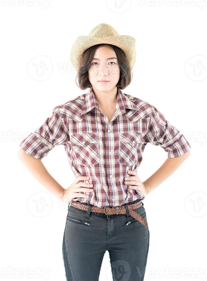 Young woman in a cowboy hat and plaid shirt photo