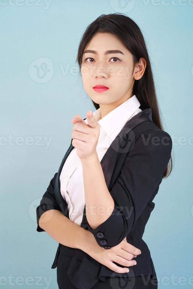 Woman looking at camera and pointing finger photo