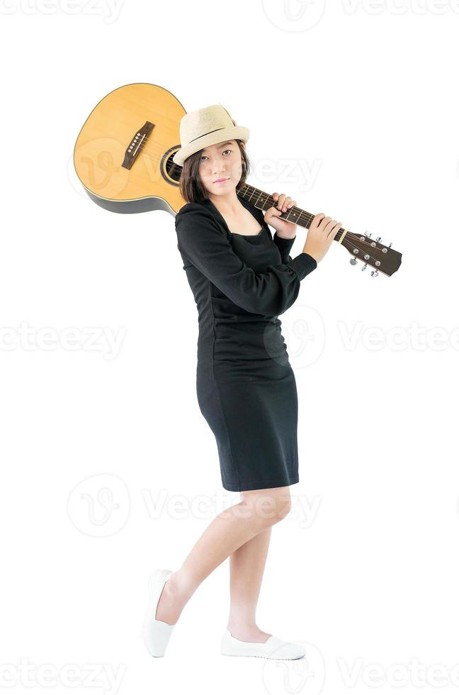 Woman carrying acoustic guitar on shoulder photo