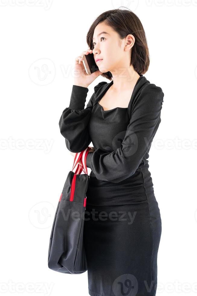 Woman carrying a black shopping bag using cellphone shopping online photo