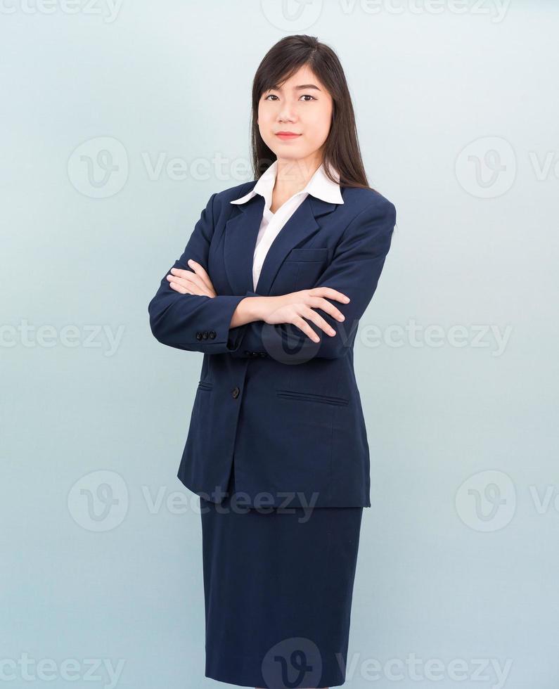 Teenage girl long hair is standing with her arms crossed photo