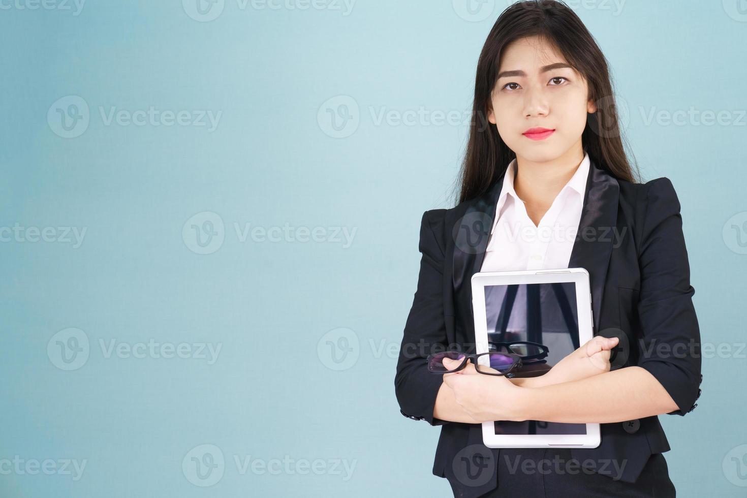 Young women standing in suit holding digital tablet photo