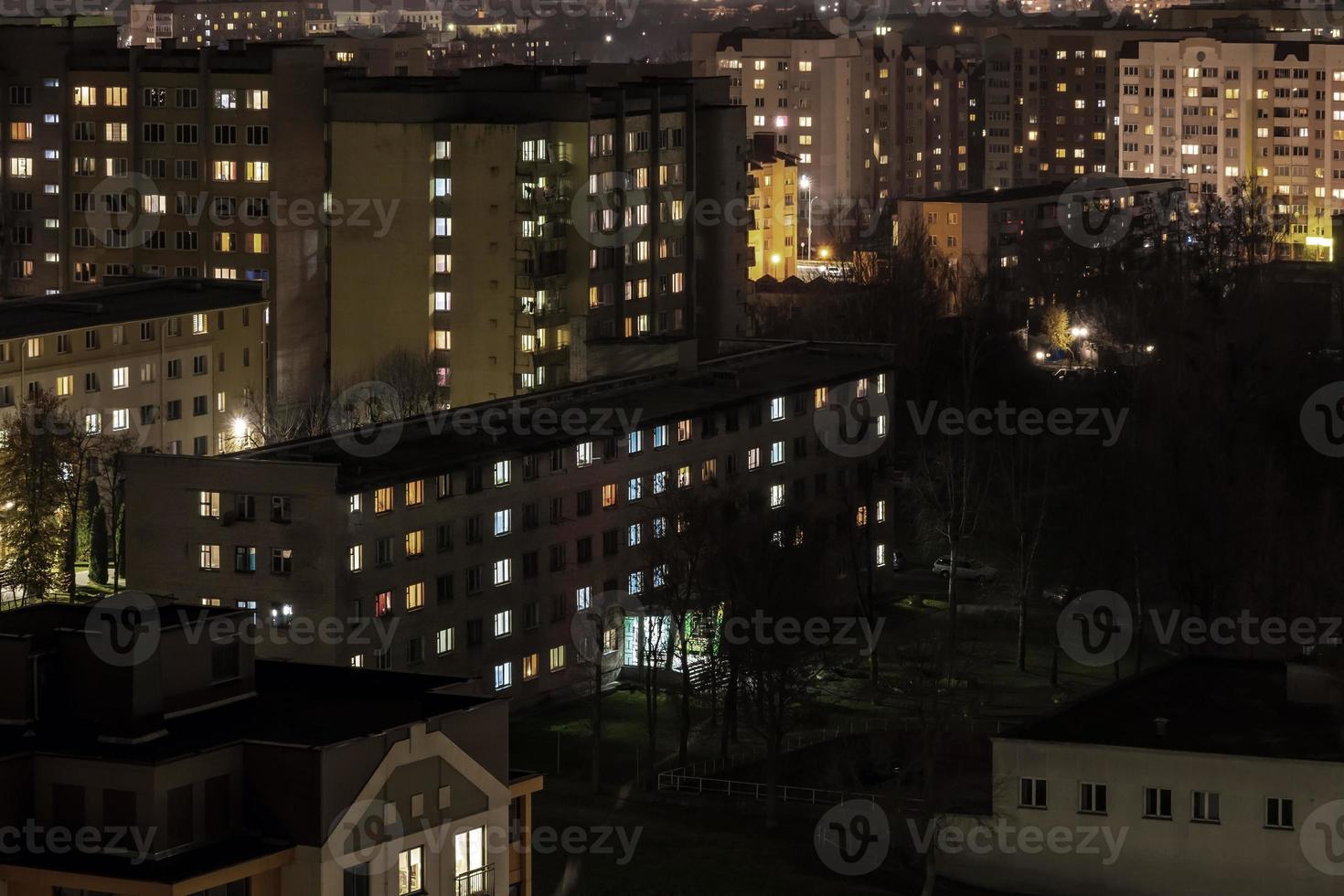 Night panorama of Light in the windows of a multistory building. life in a big city photo