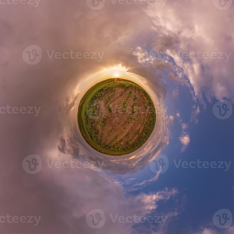 tiny planet in blue sky with beautiful clouds. Transformation of spherical panorama 360 degrees. Spherical abstract aerial view. Curvature of space. photo