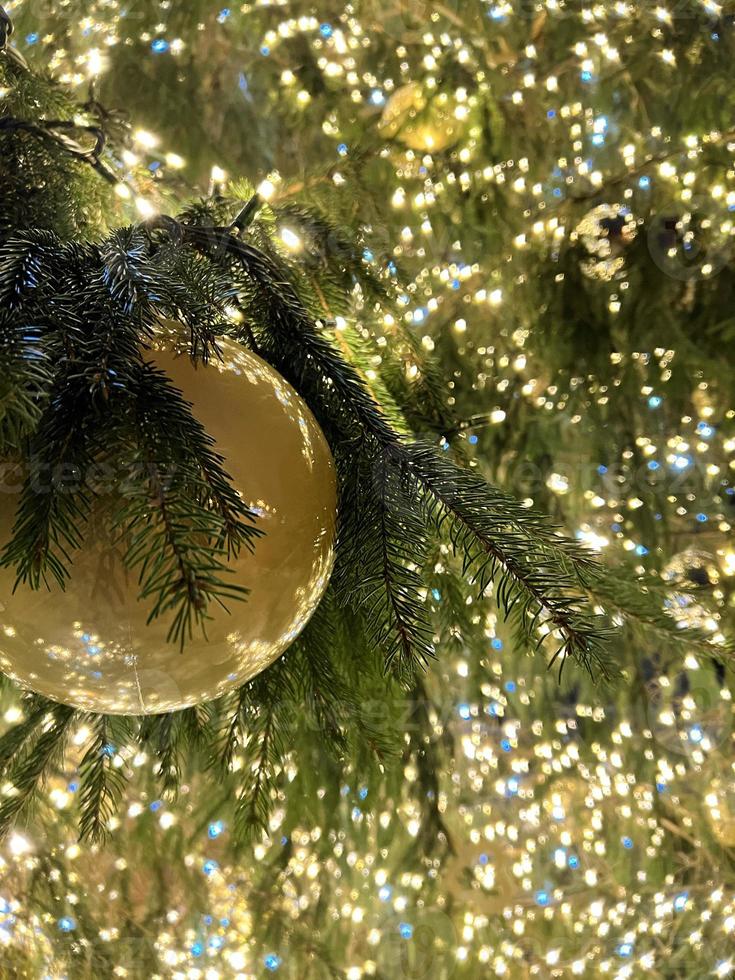 Christmas banner with copy space and sparkles for greeting card. Fir branch with red balls, festive yellow lights and bokeh. Perfect content for advertising banners, gift card or creative projects. photo