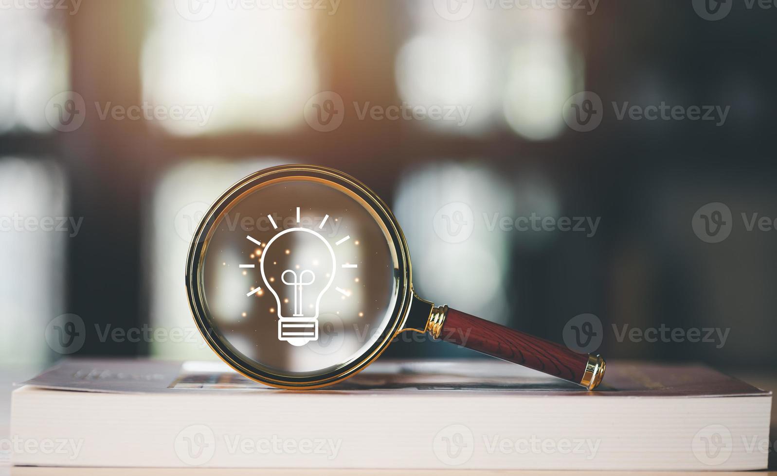 for Concept new idea, concept with innovation and inspiration, innovative technology in science concept and modern business development,creative idea,a magnifying glass is placed on the book photo