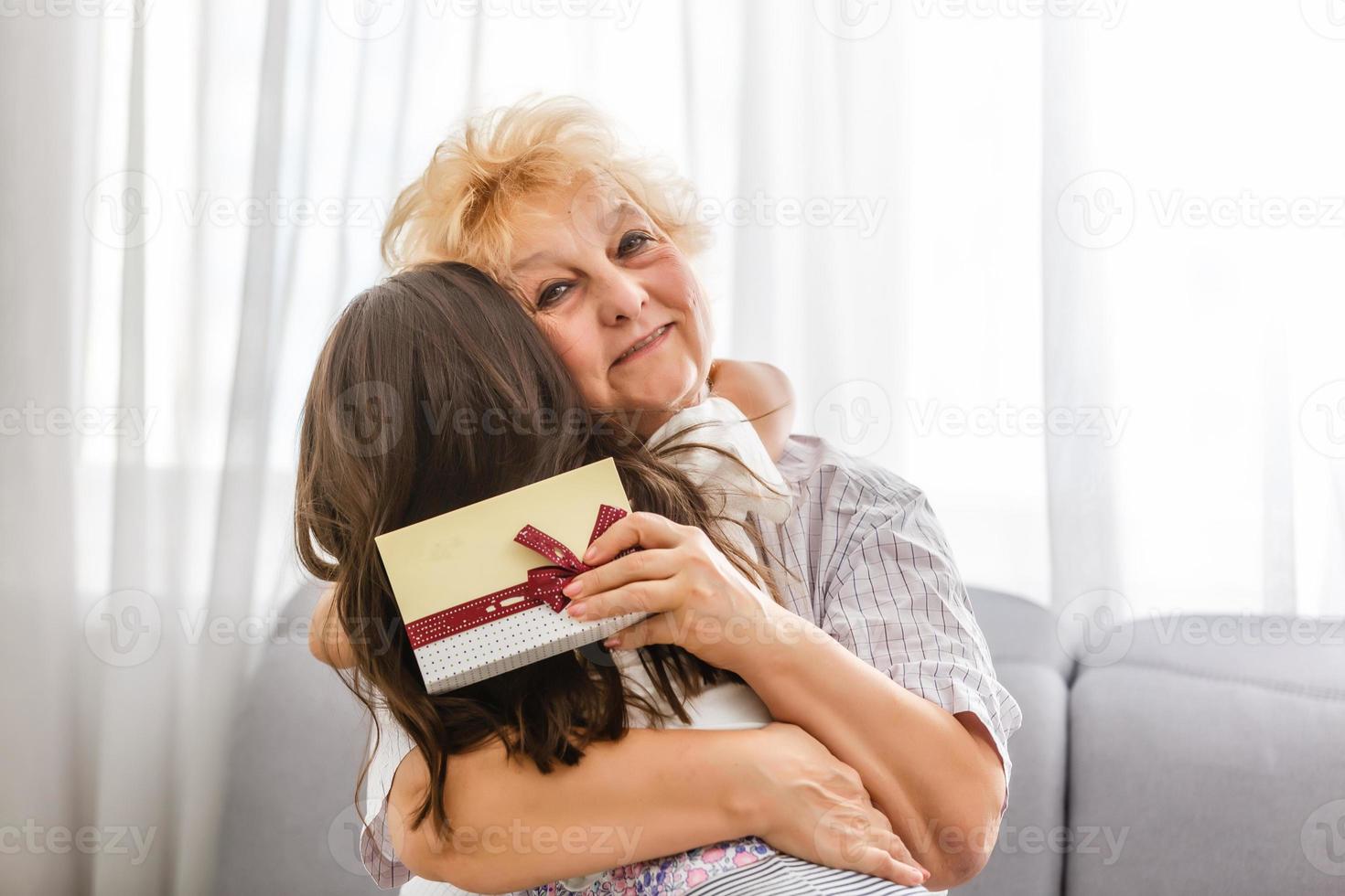 granddaughter gives grandmother a gift photo
