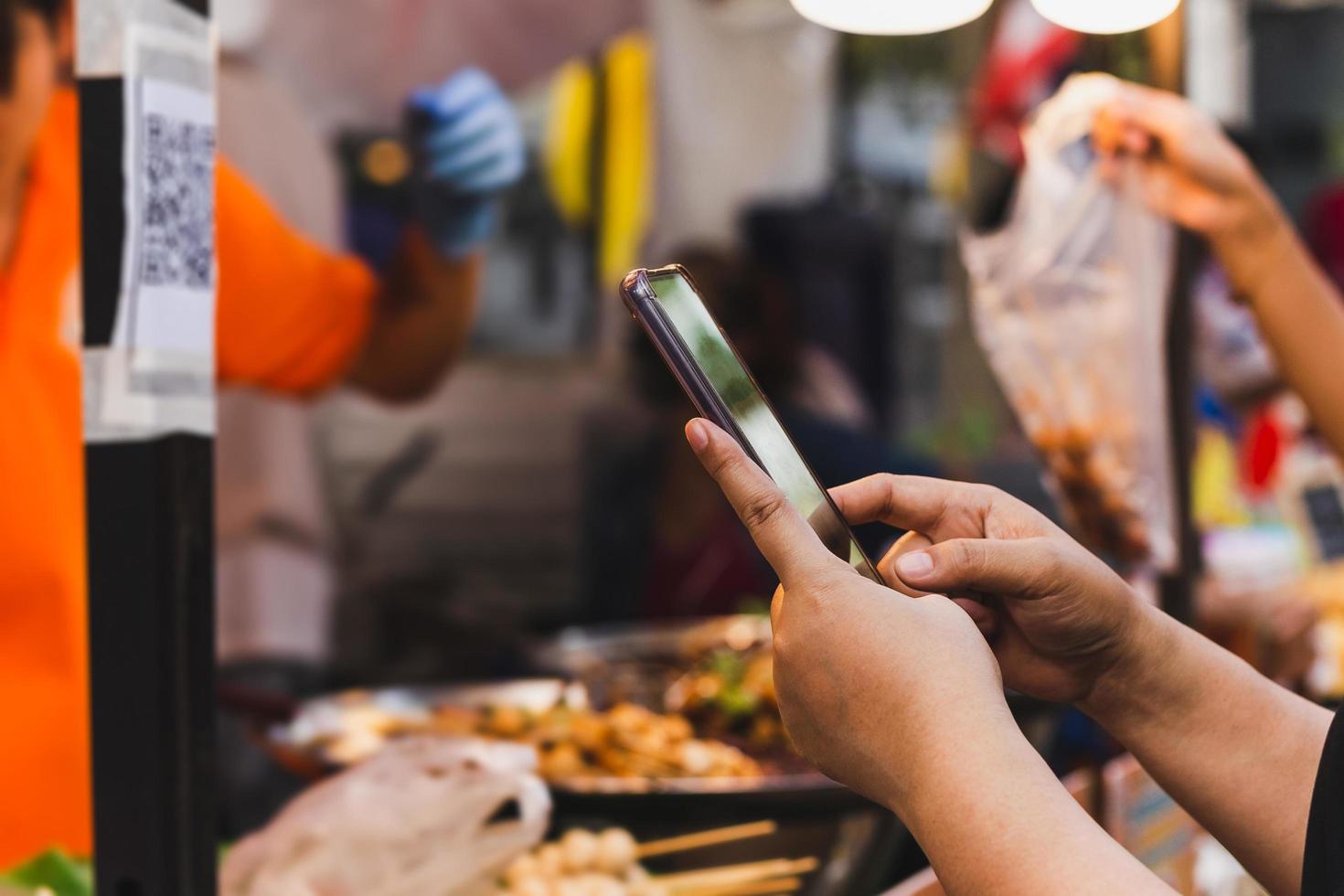 Woman use smartphone scan QR code in food store. photo