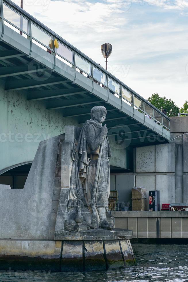 Pont de l'Alma is a road bridge in Paris across the Seine and Zouave statue. photo