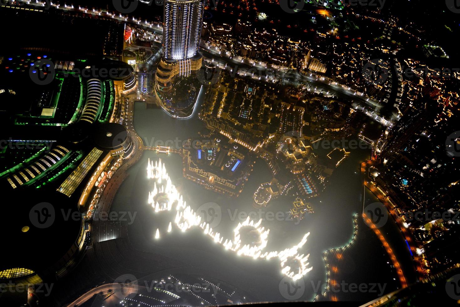 Aerial view of the skyline in Dubai, United Arab Emirates at night photo