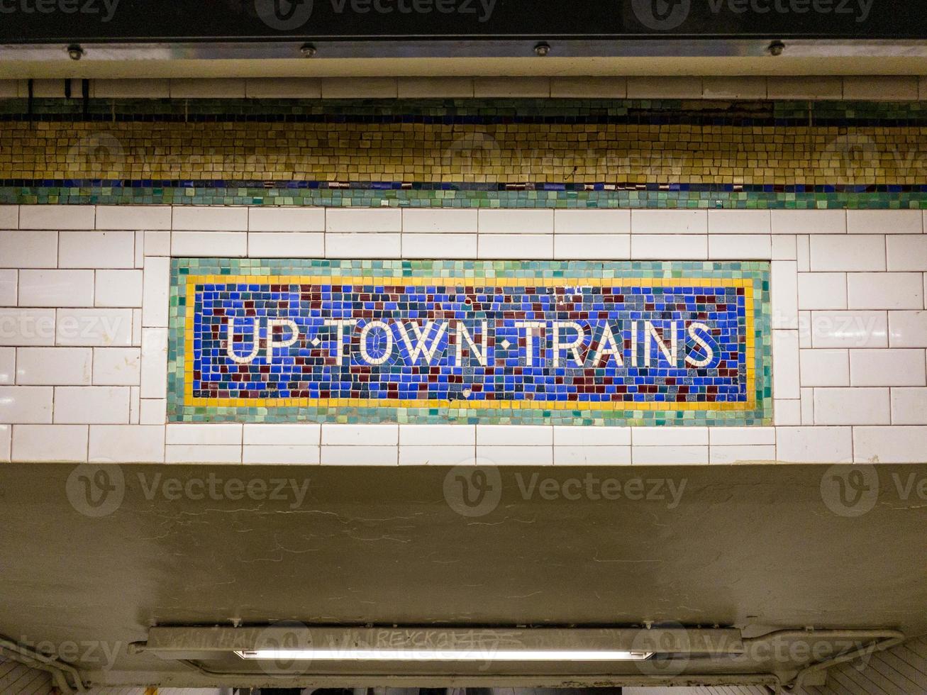 Vintage sign for uptown trains made of mosaic tiles. photo