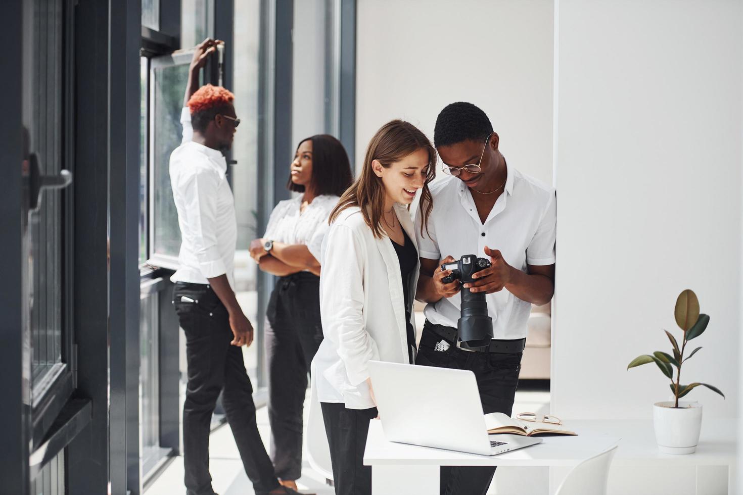 Looking at the camera. Group of african american business people working in office together photo