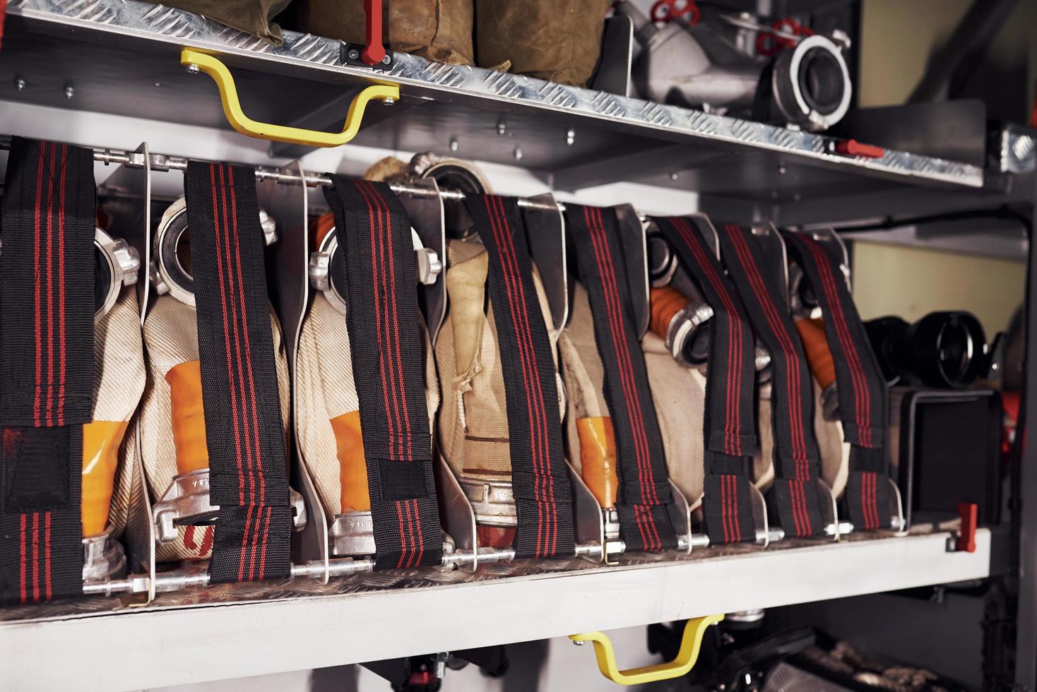 Firefighter's equipment in the car. Hoses hanging inside of vehicle photo