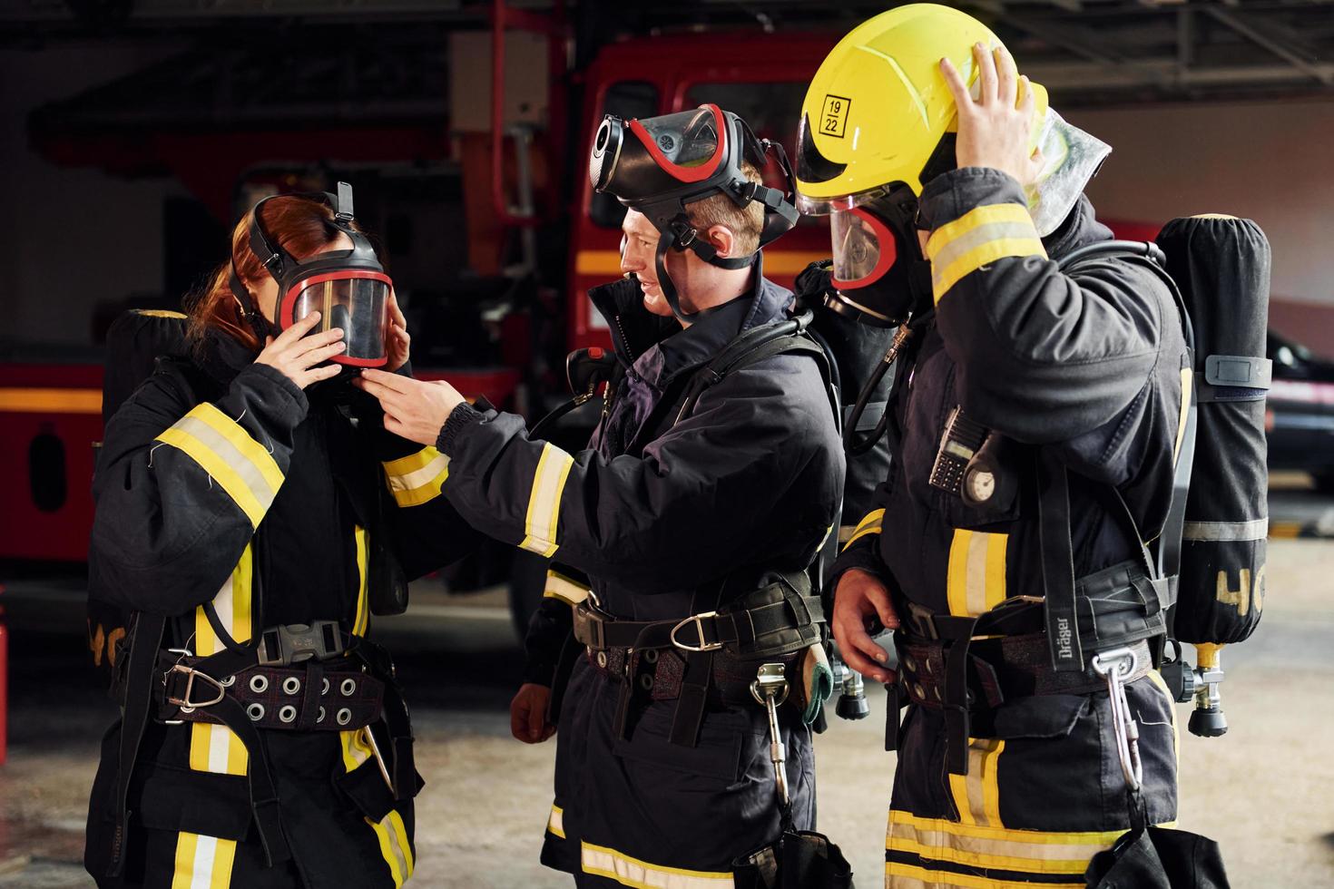 Wearing protective uniform. Group of firefighters that is on station photo