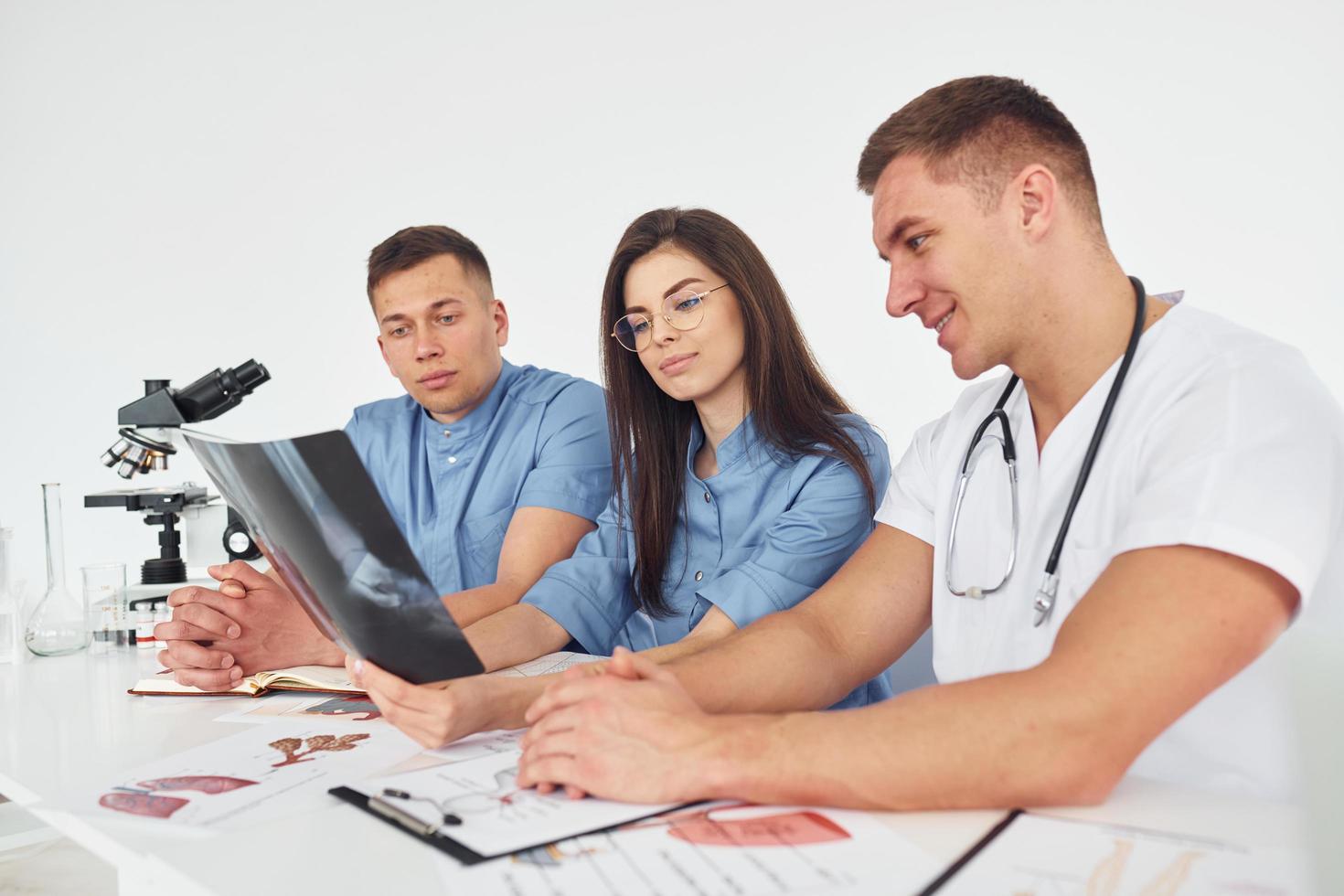 X-ray of legs. Group of young doctors is working together in the modern office photo