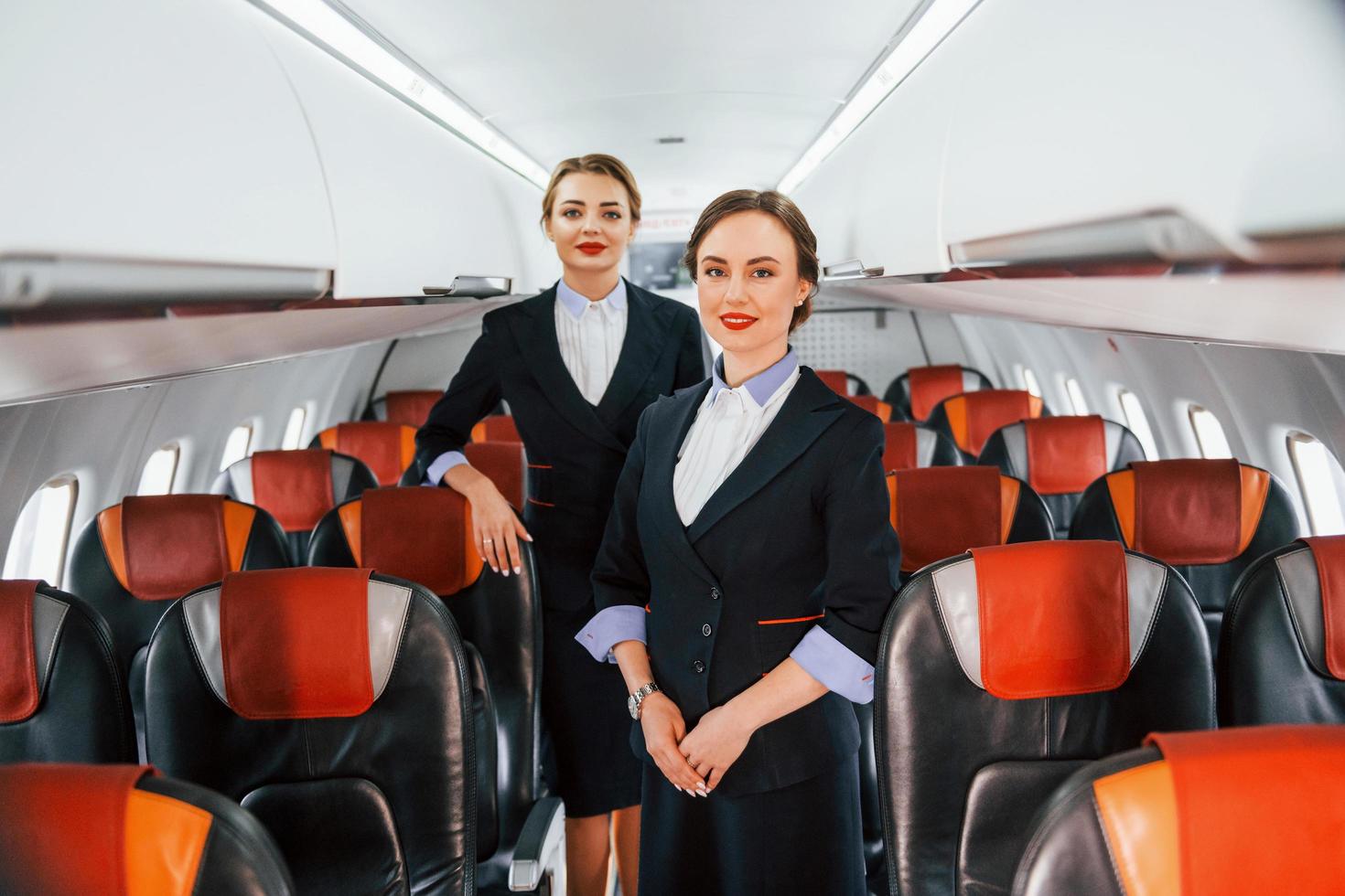 dos azafatas en el trabajo en el avión de pasajeros foto