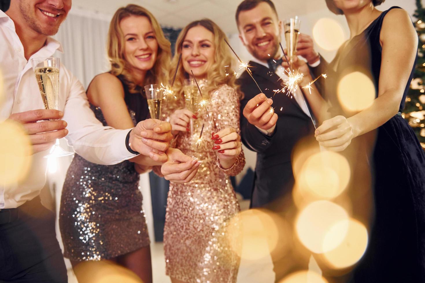 Talking and having fun. Group of people have a new year party indoors together photo