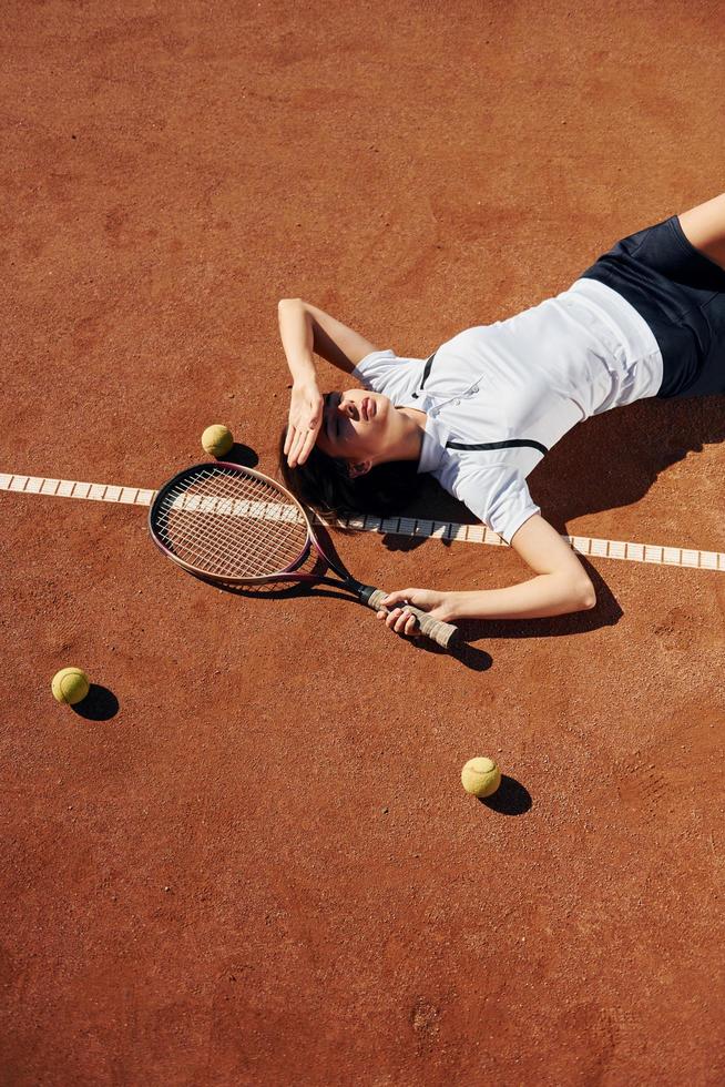 View from above. Female tennis player is on the court at daytime photo