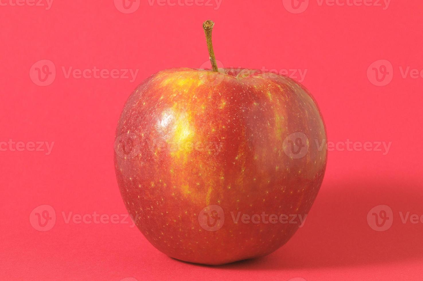 Red apple in red background photo