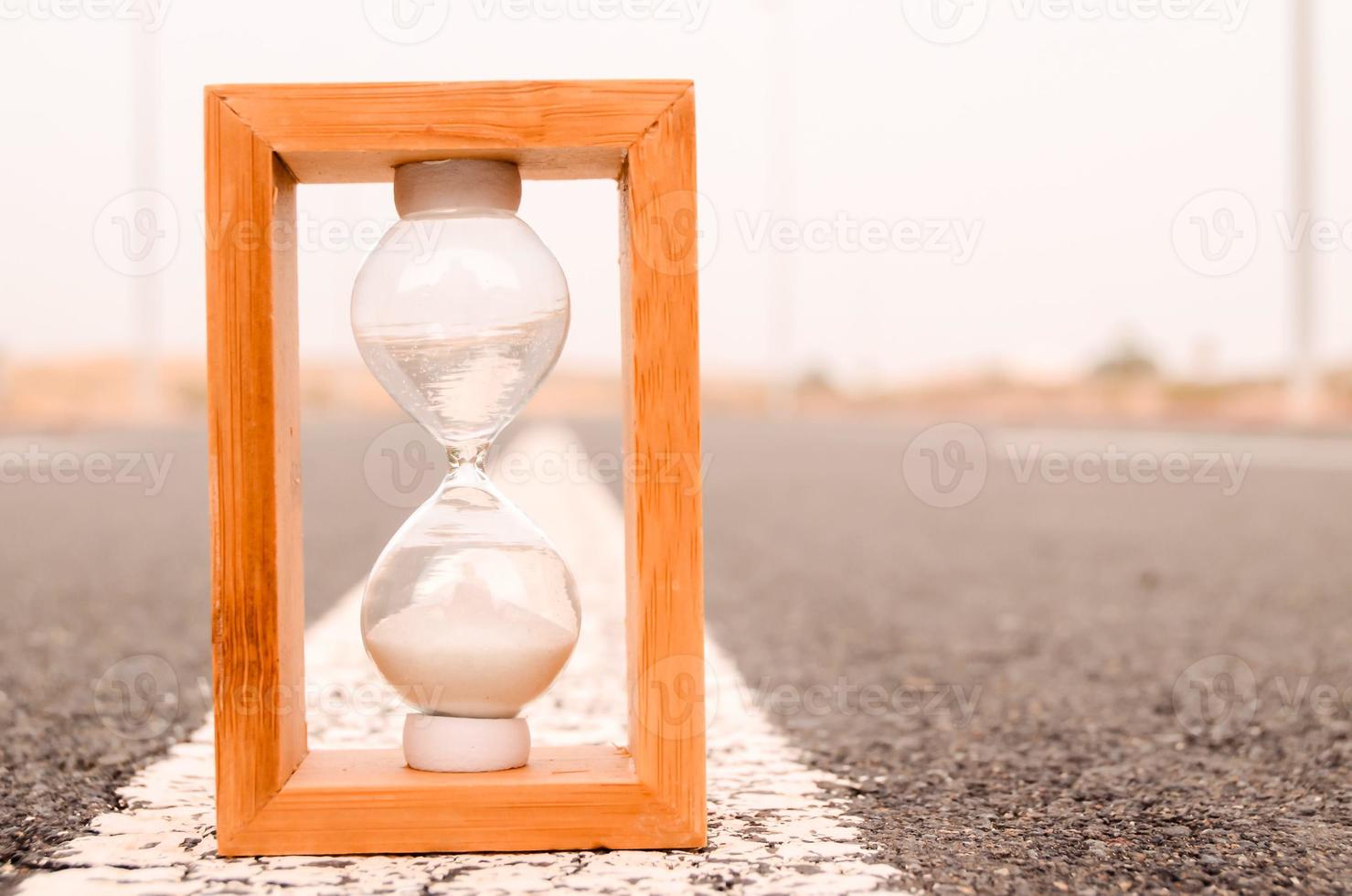 Hourglass on the ground photo