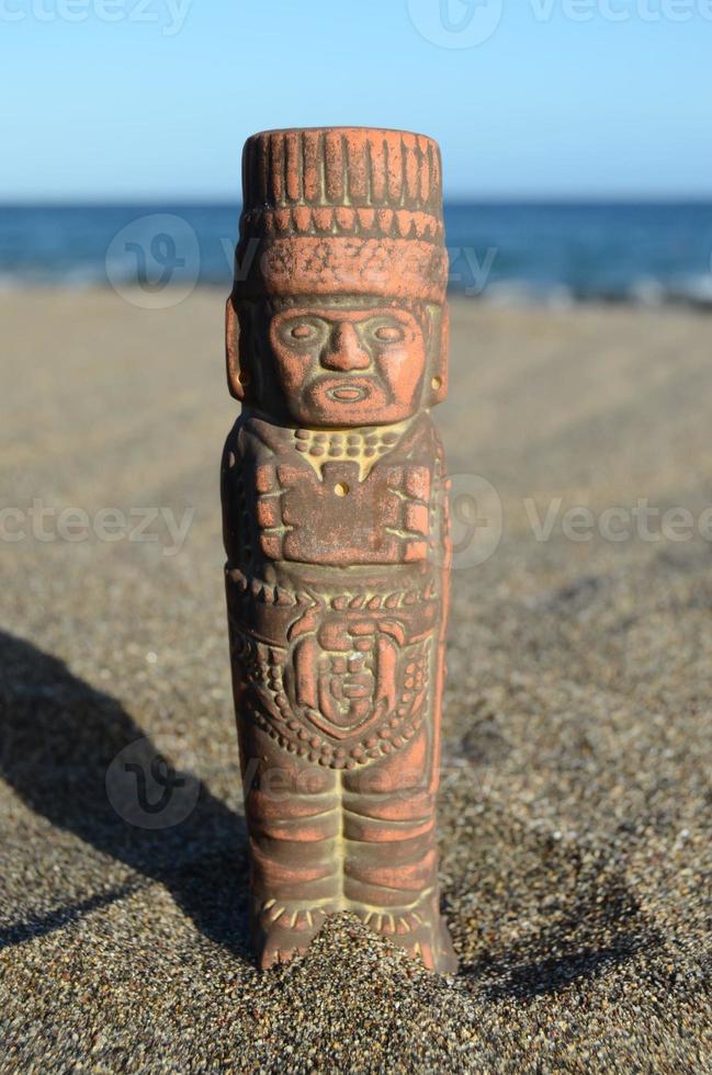 Pre Columbian miniature on the beach sand photo