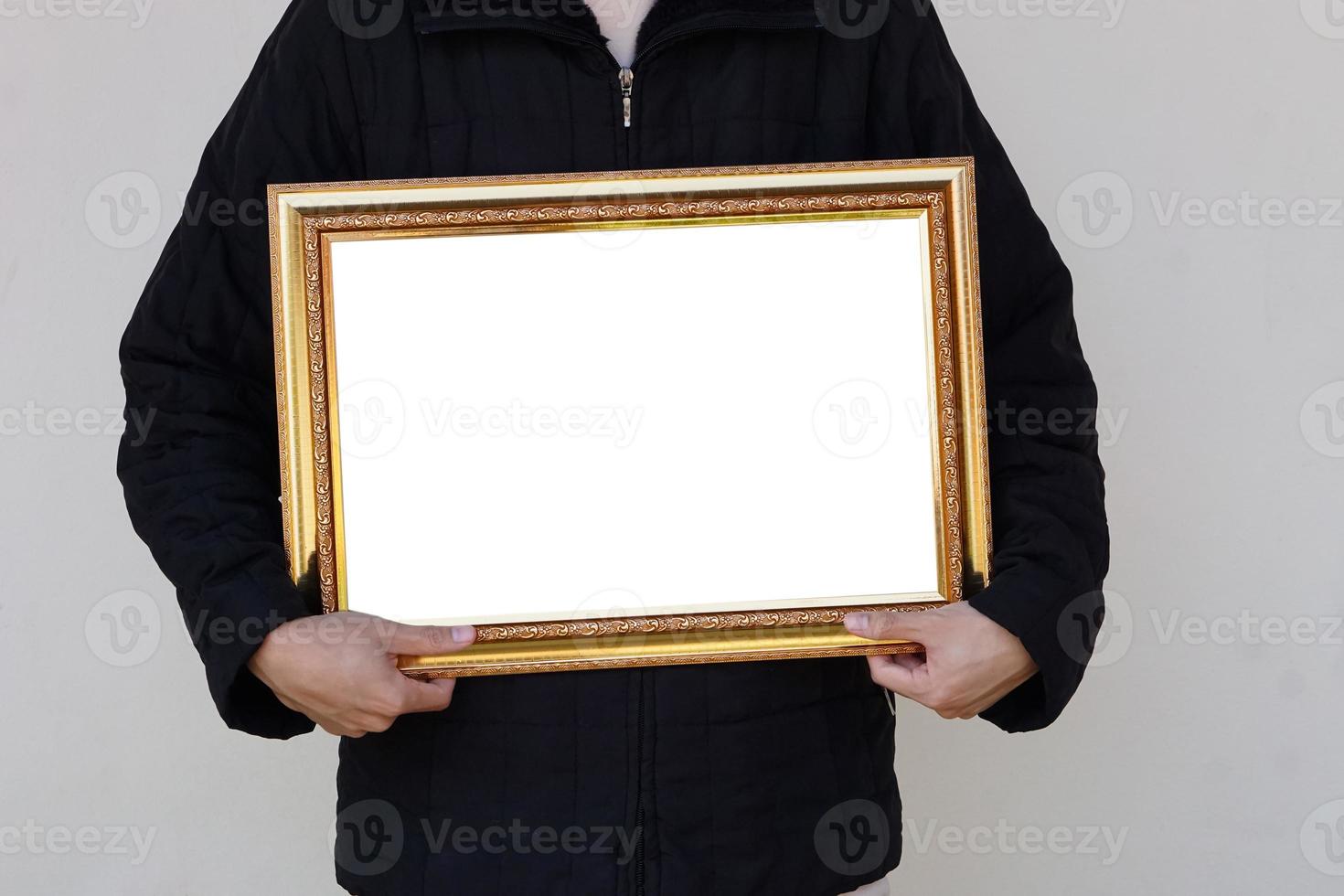 Closeup man holds empty photo frame or blank diploma certificate frame. Copy space for adding text or photos.  Concept , Proud, memories and nostalgia .