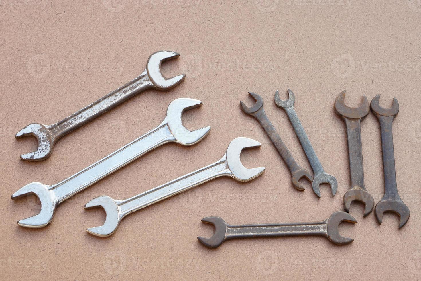 Set of metal wrenches  isolated on brown. Concept, handyman, mechanic tools. Spanners. Equipment for fixing or repairing, renovation in daily life. photo