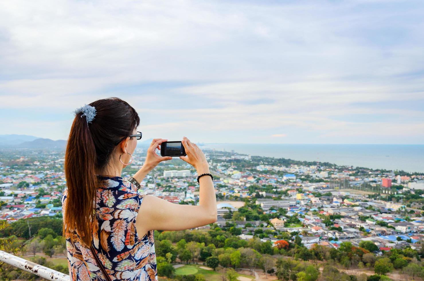 Woman using phone taking pictures photo