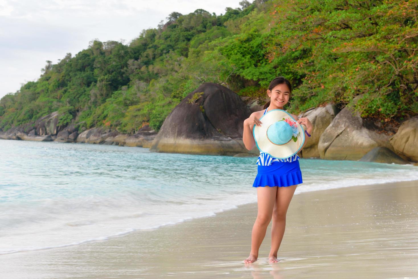 Girl on the beach at sunrise over the sea photo