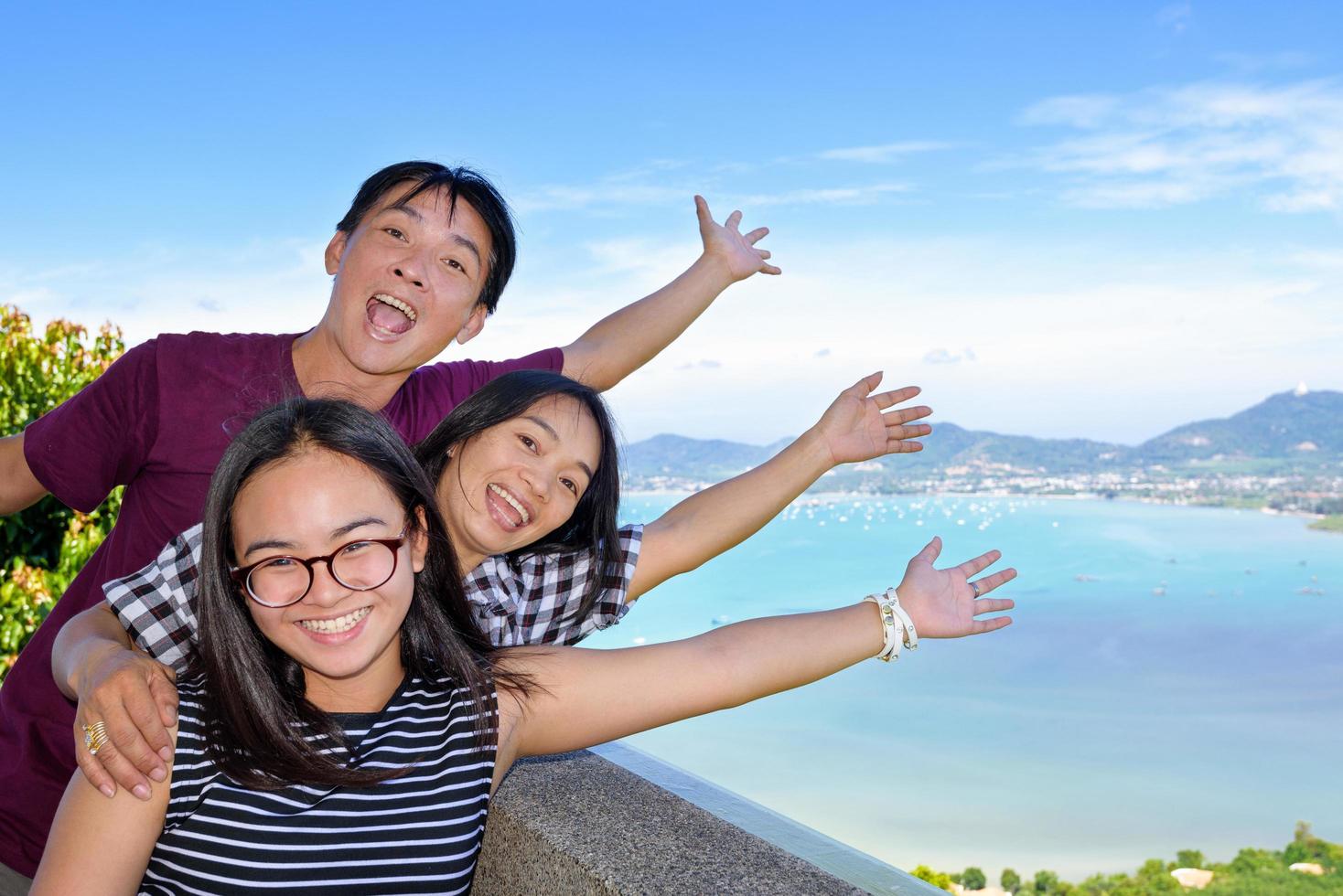 Family of tourists inviting to see the sea in Phuket, Thailand photo