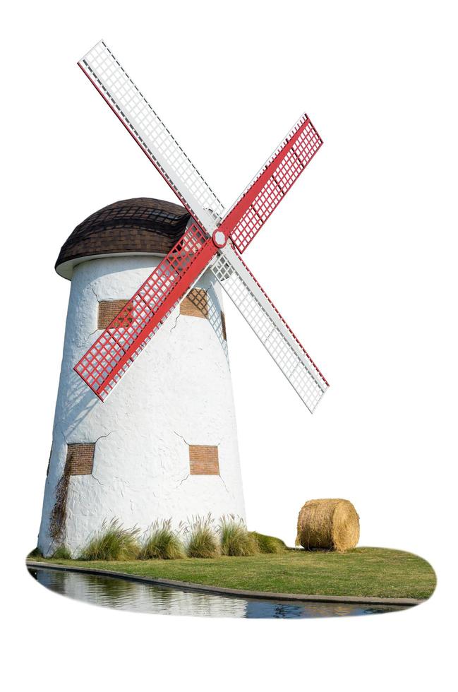 Windmill and straw in the lawn photo