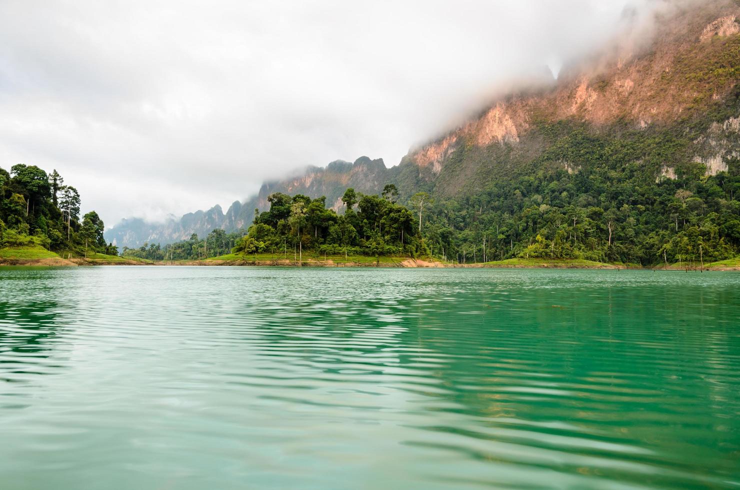 Beautiful high mountains and green lake photo